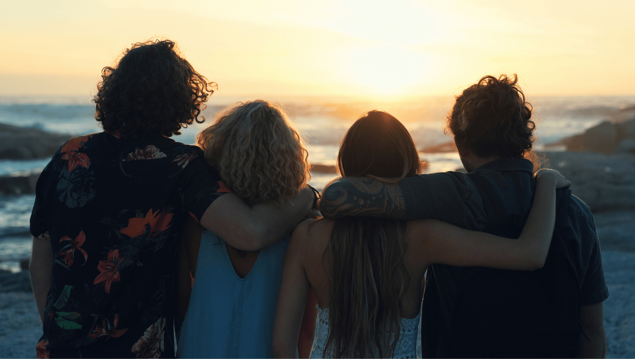 Four people looking at the sunset