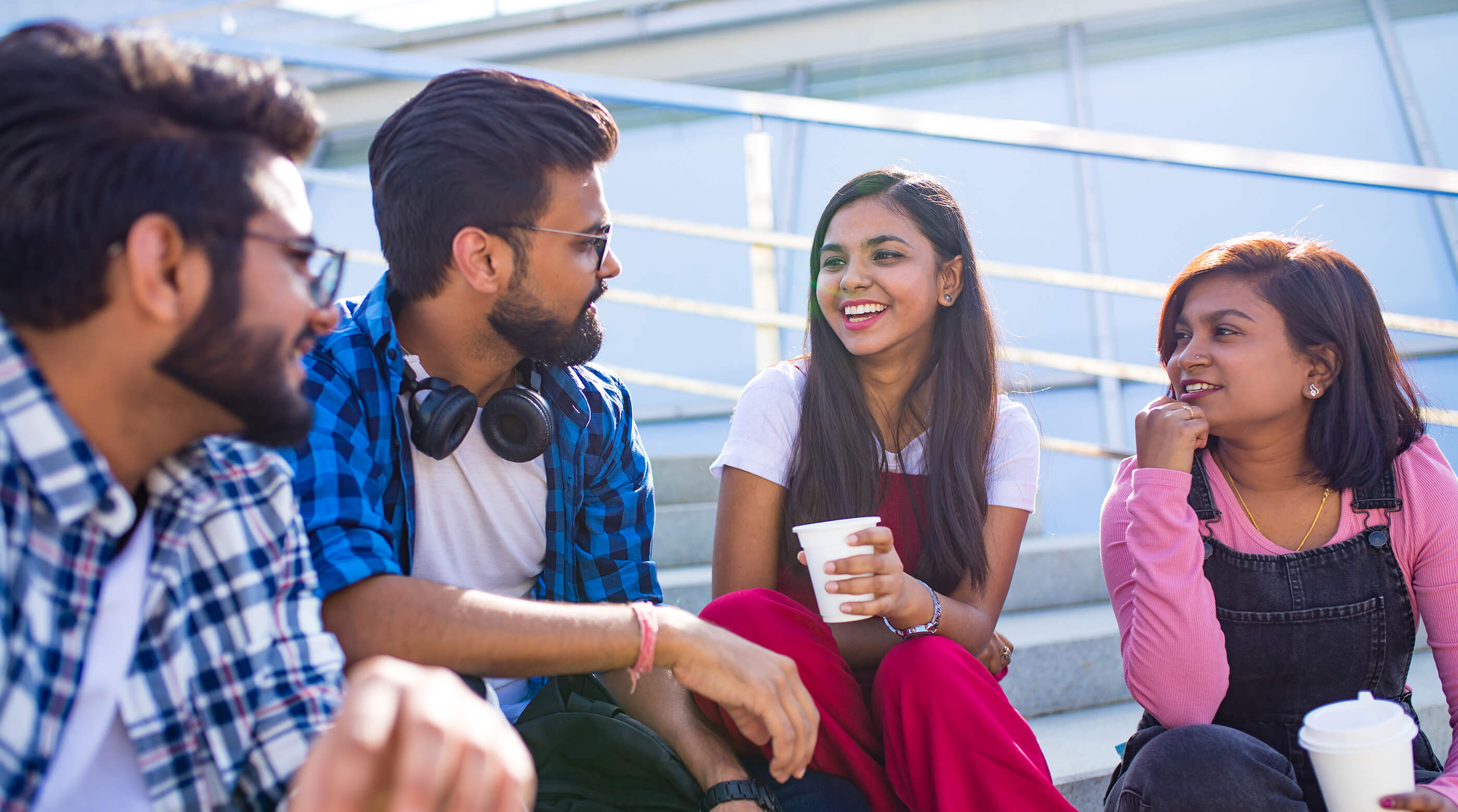 South Asian young adults sitting on bleachers 