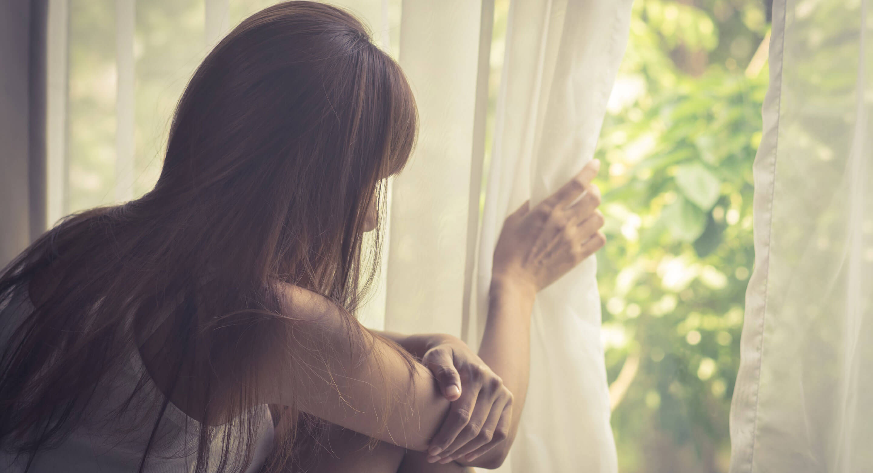 Girl looking outside window