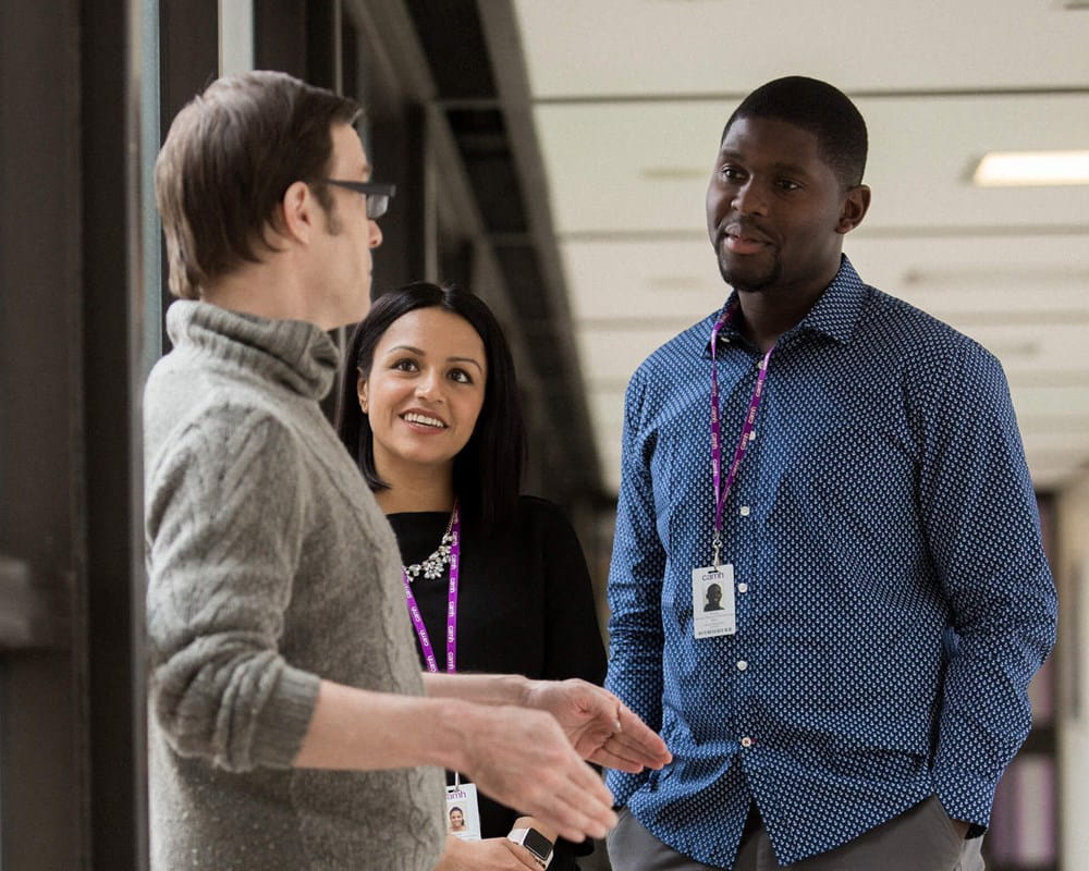 CAMH staff members converse in the hallway.