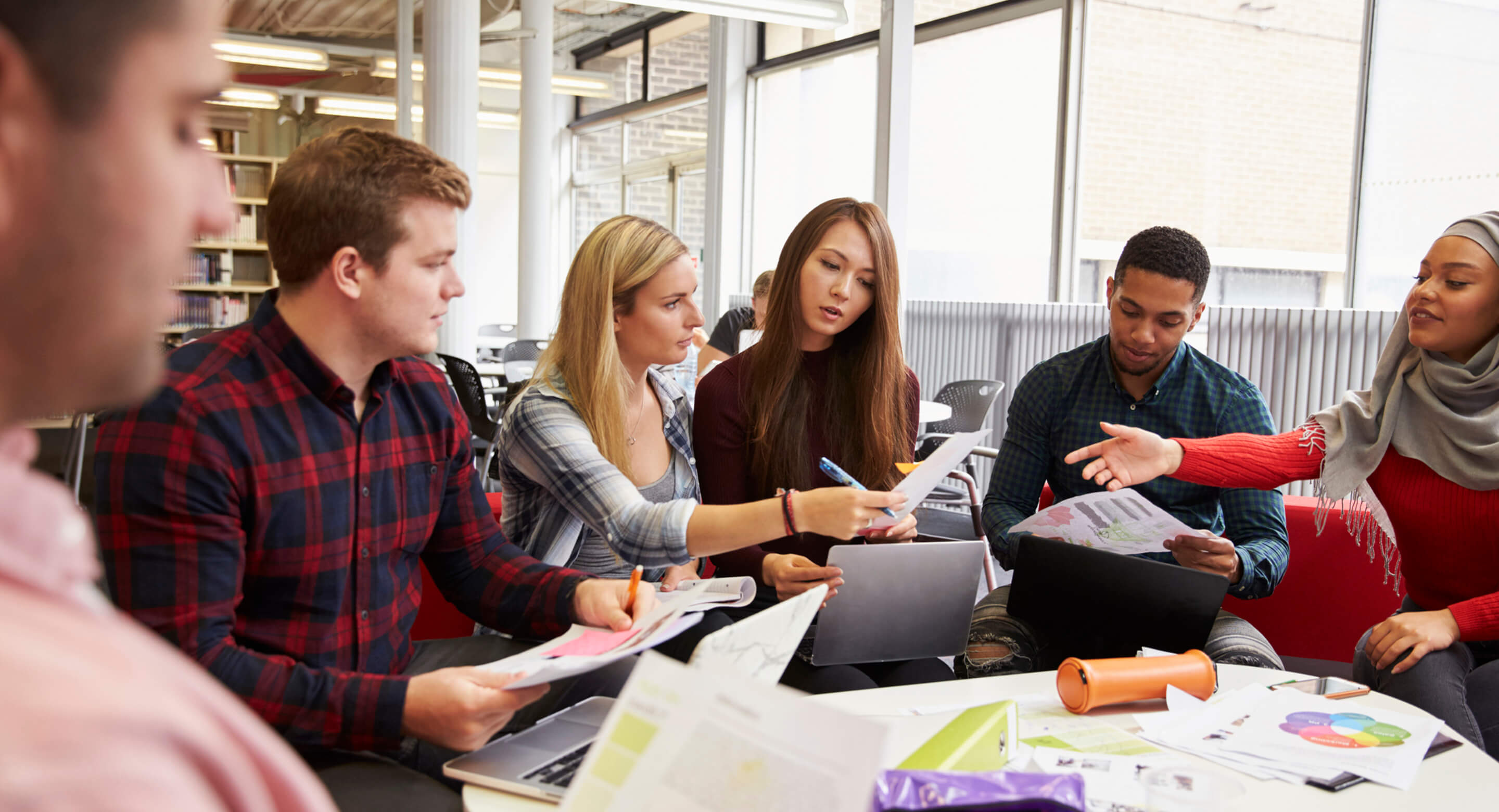 A group of young professionals discuss public policy.