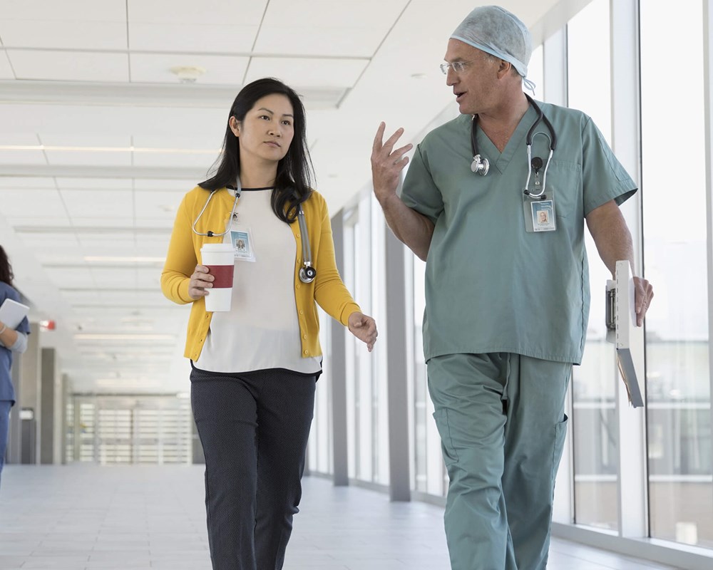 Doctors and medical professionals walking in hallway