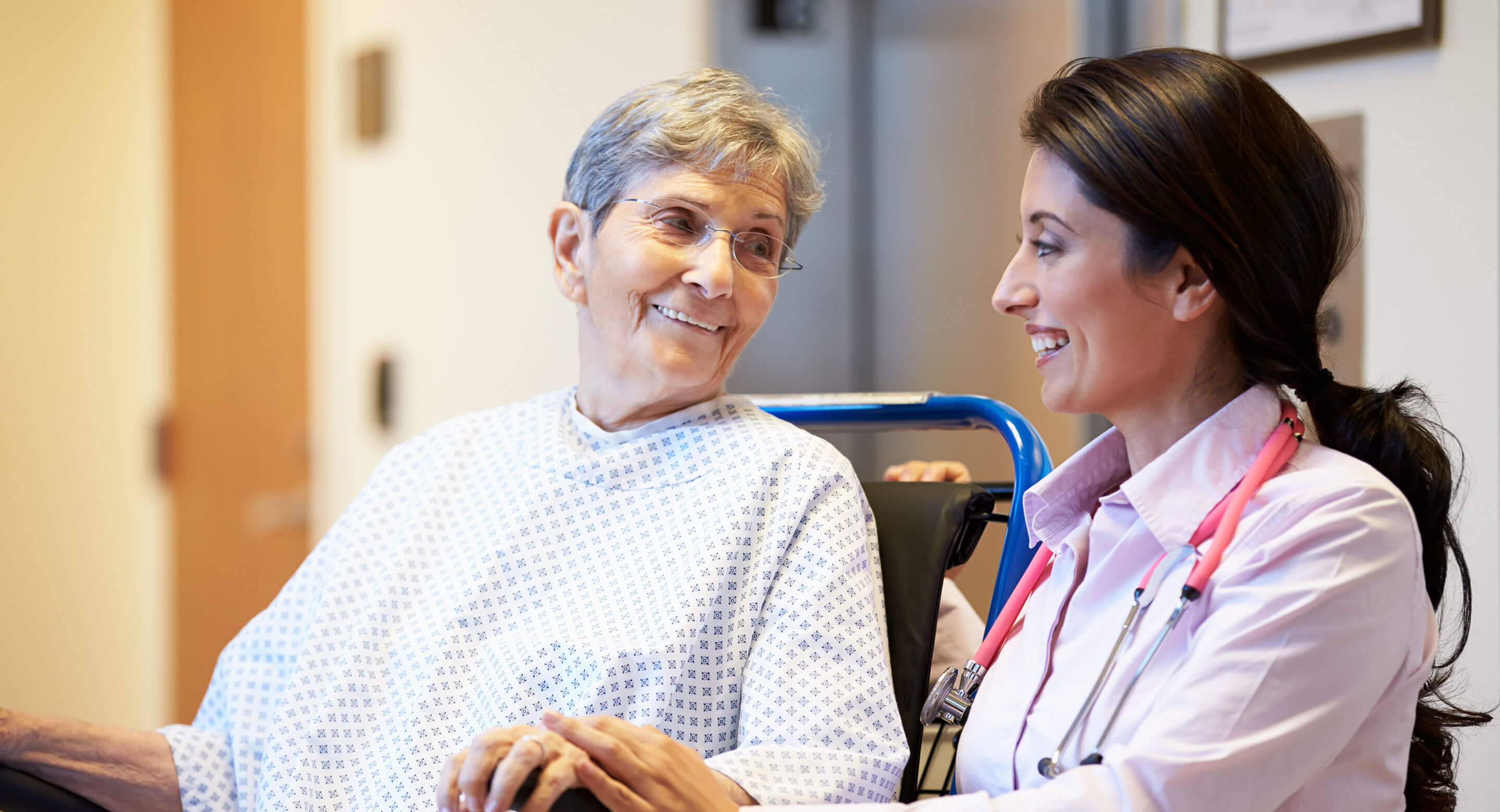 Doctor helping elderly woman. Doctor also happens to be female.