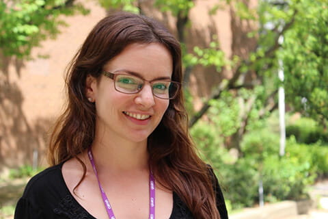 A medium-close up shot of a CAMH social worker wearing glasses and a purple lanyard. 