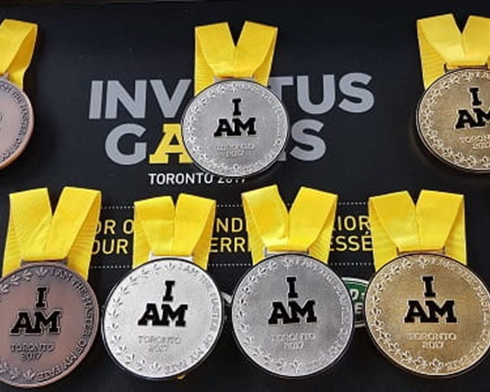 3 bronze, 3 silver, and 3 gold medals attached to a yellow ribbon with 