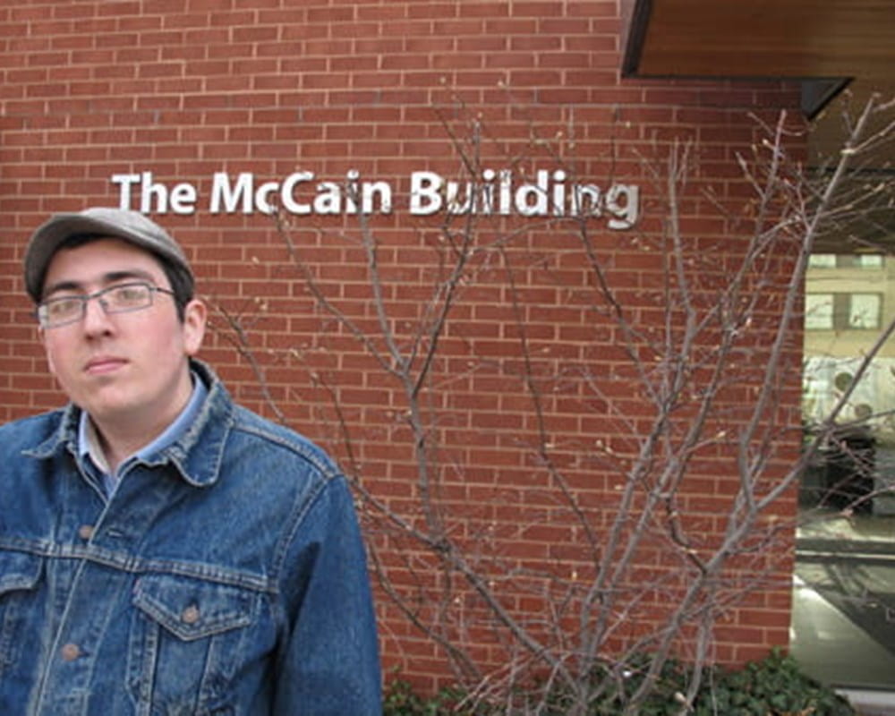 Jason standing in front of the McCain Centre. 