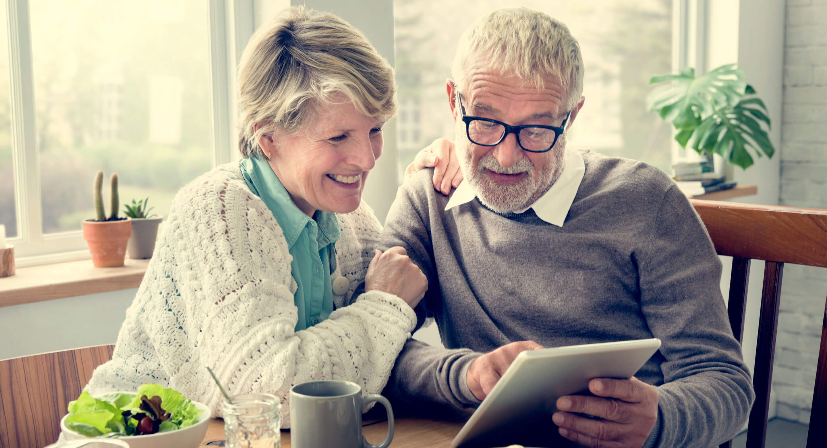 Older couple reading a tablet