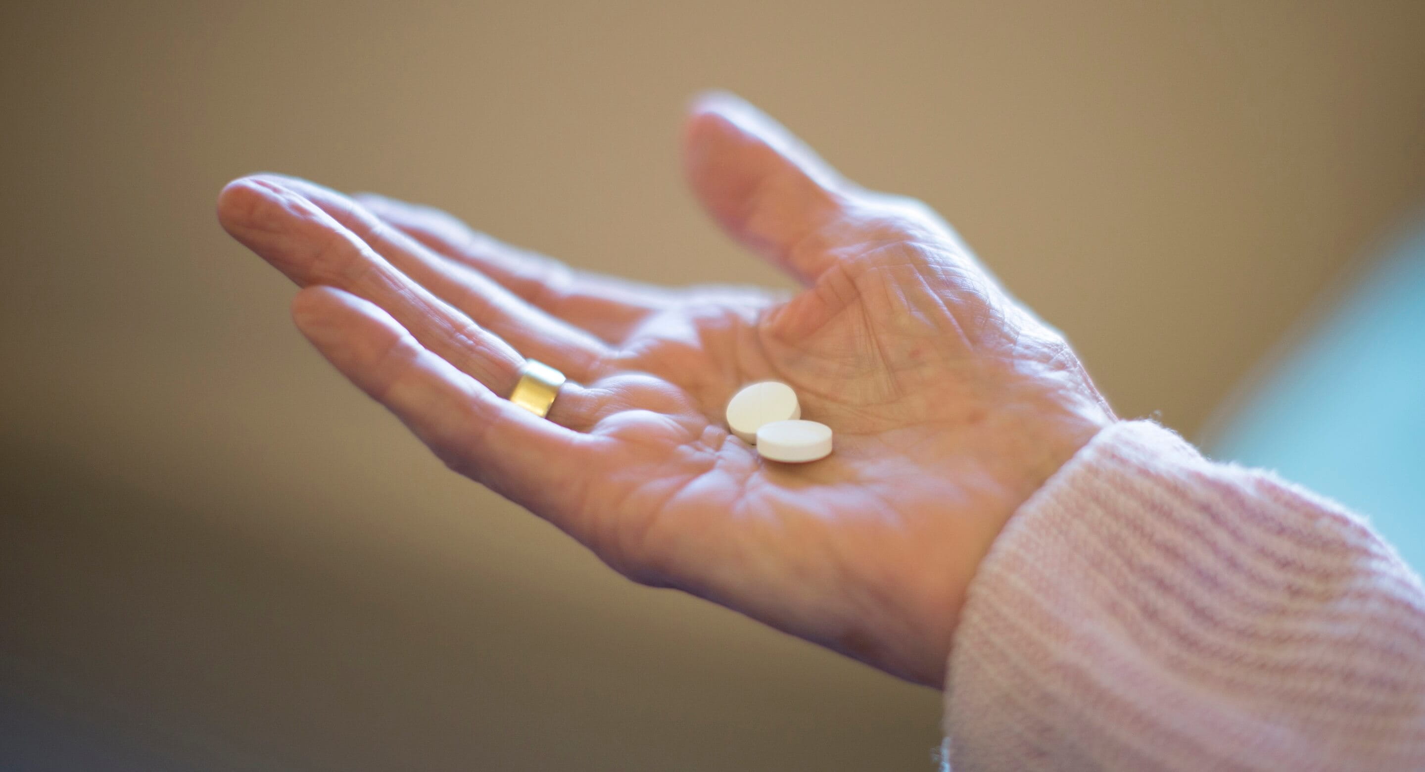 Woman's hand holding pills