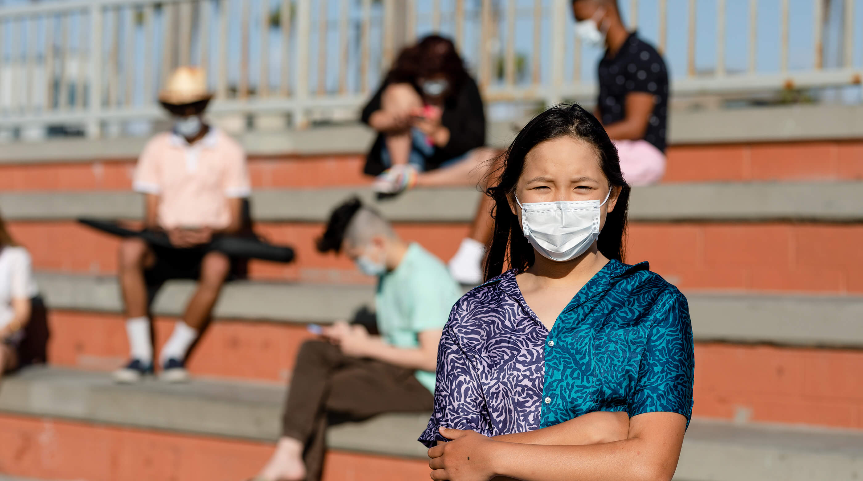 Worried teen girl wearing a mask