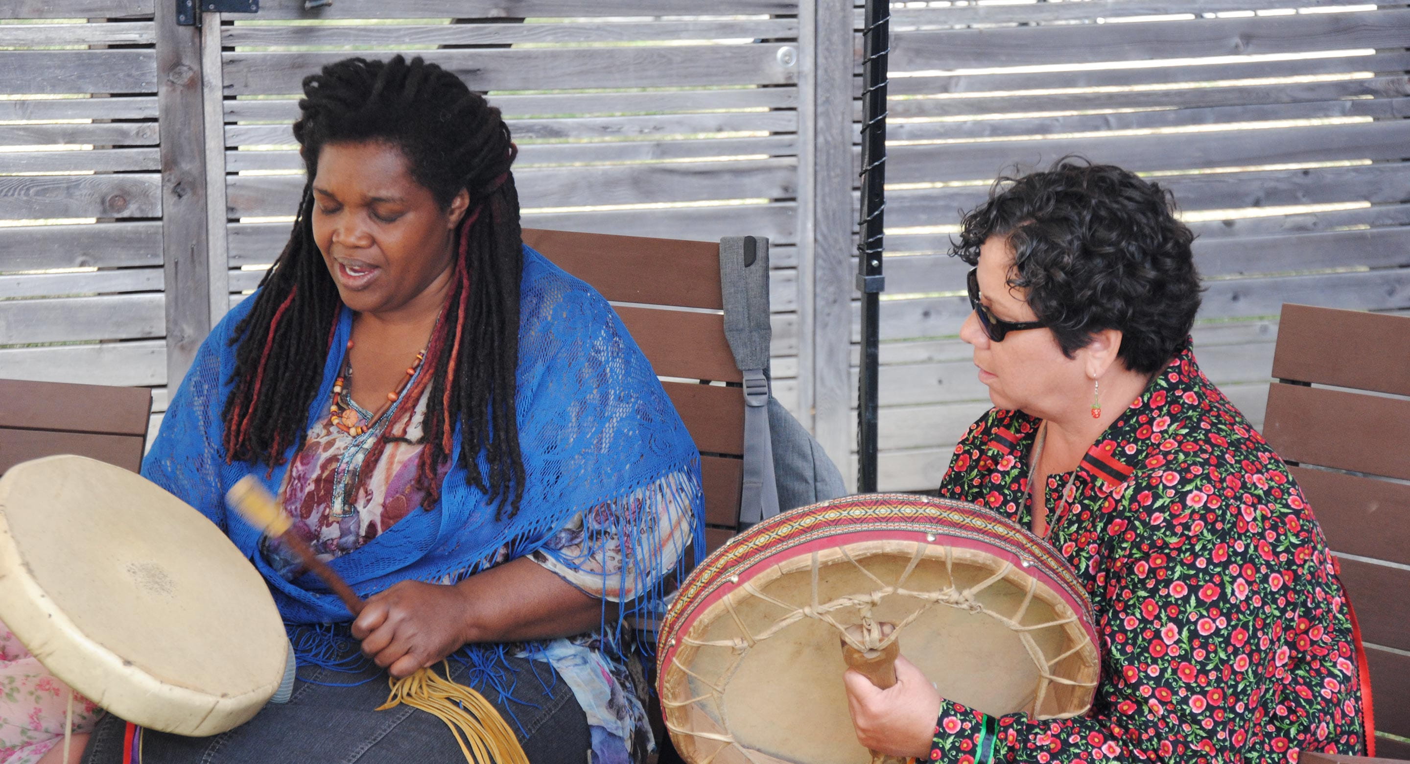 Michele Perpaul and Elder Cynthia White celebrate the opening of CAMH’s Ceremony Grounds in 2016 with a drum circle.