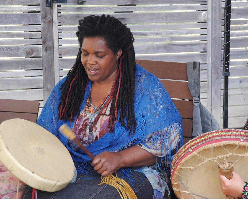 Michele Perpaul and Elder Cynthia White celebrate the opening of CAMH’s Ceremony Grounds in 2016 with a drum circle.