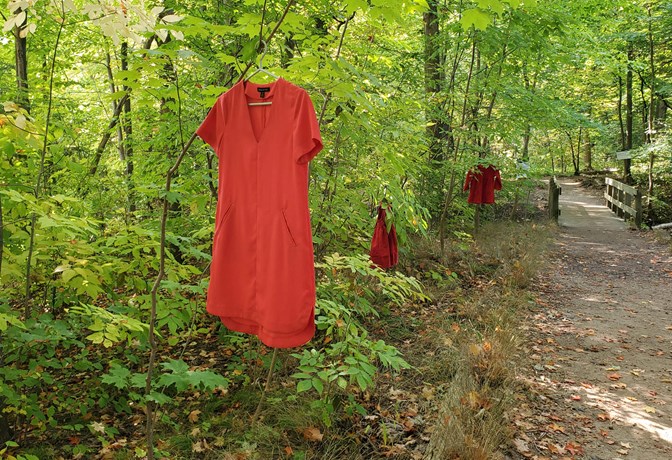 Red dresses hanging from trees