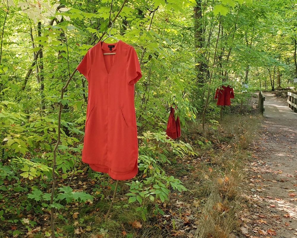 Red dresses hanging from trees