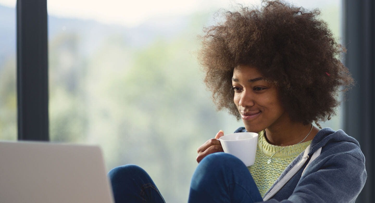 Woman looking at computer and smiling