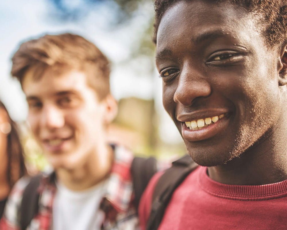 Stock photo showing young people smiling at the camera