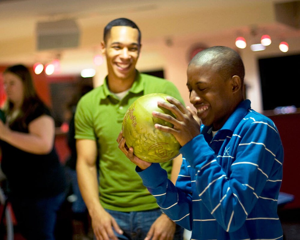 Happy young people bowling