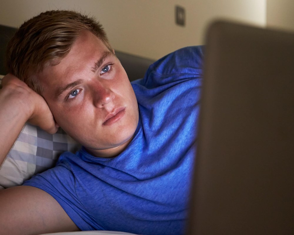Young male looking at computer screen