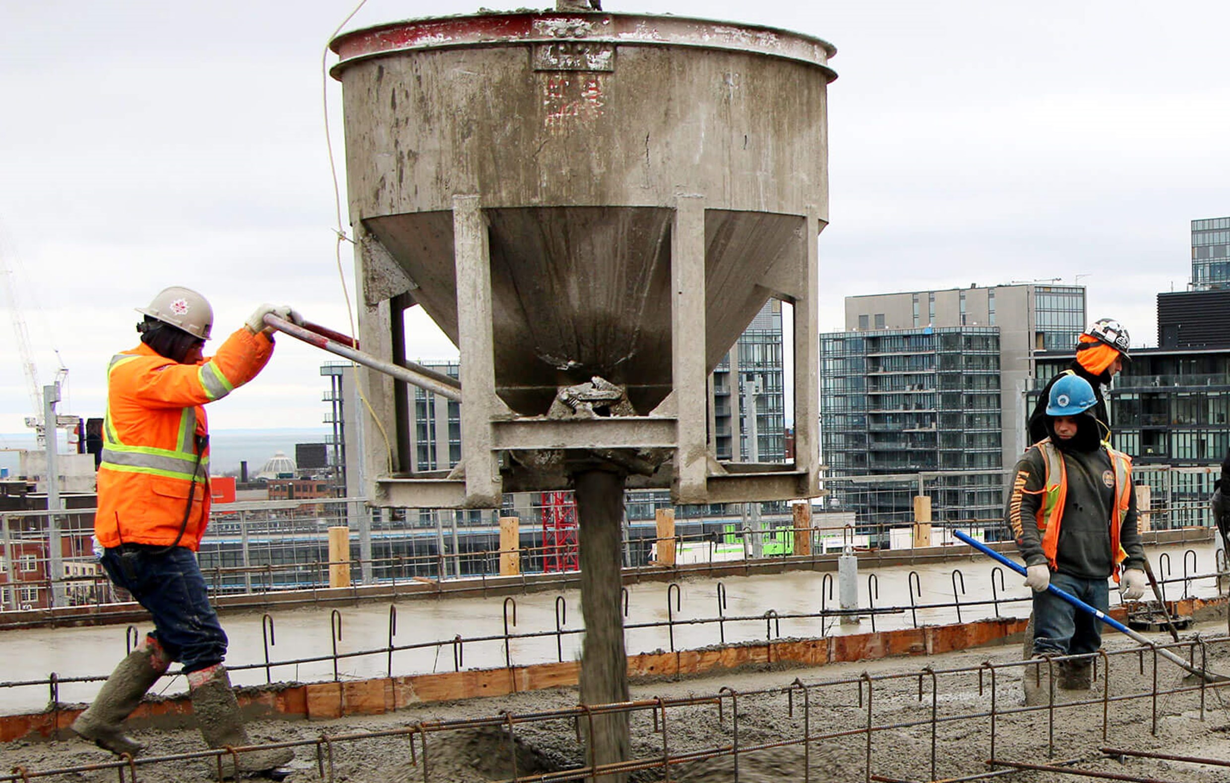 Man pouring concrete - top-off Phase 1C