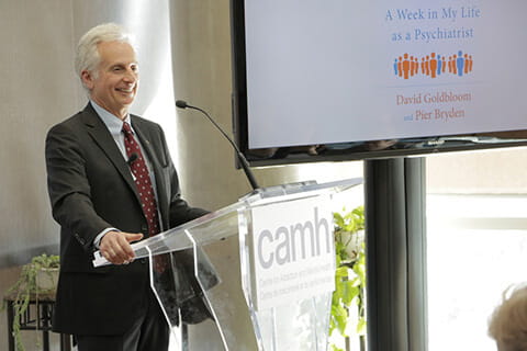 Pier Bryden speaking behind a podium.