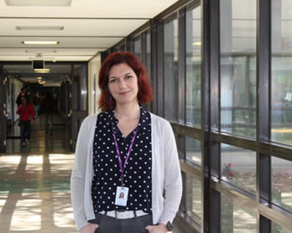 Dr. Yuliya Knyahnytska standing in a hallway.