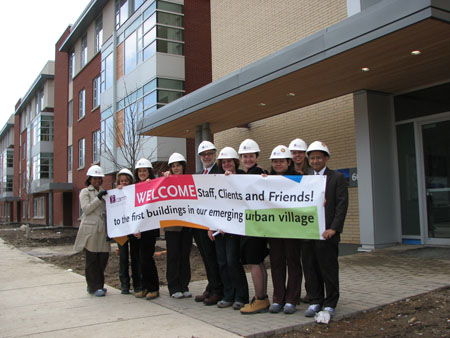 CAMH Leadership holding up a welcome sign to Phase 1A of redevelopment circa 2008