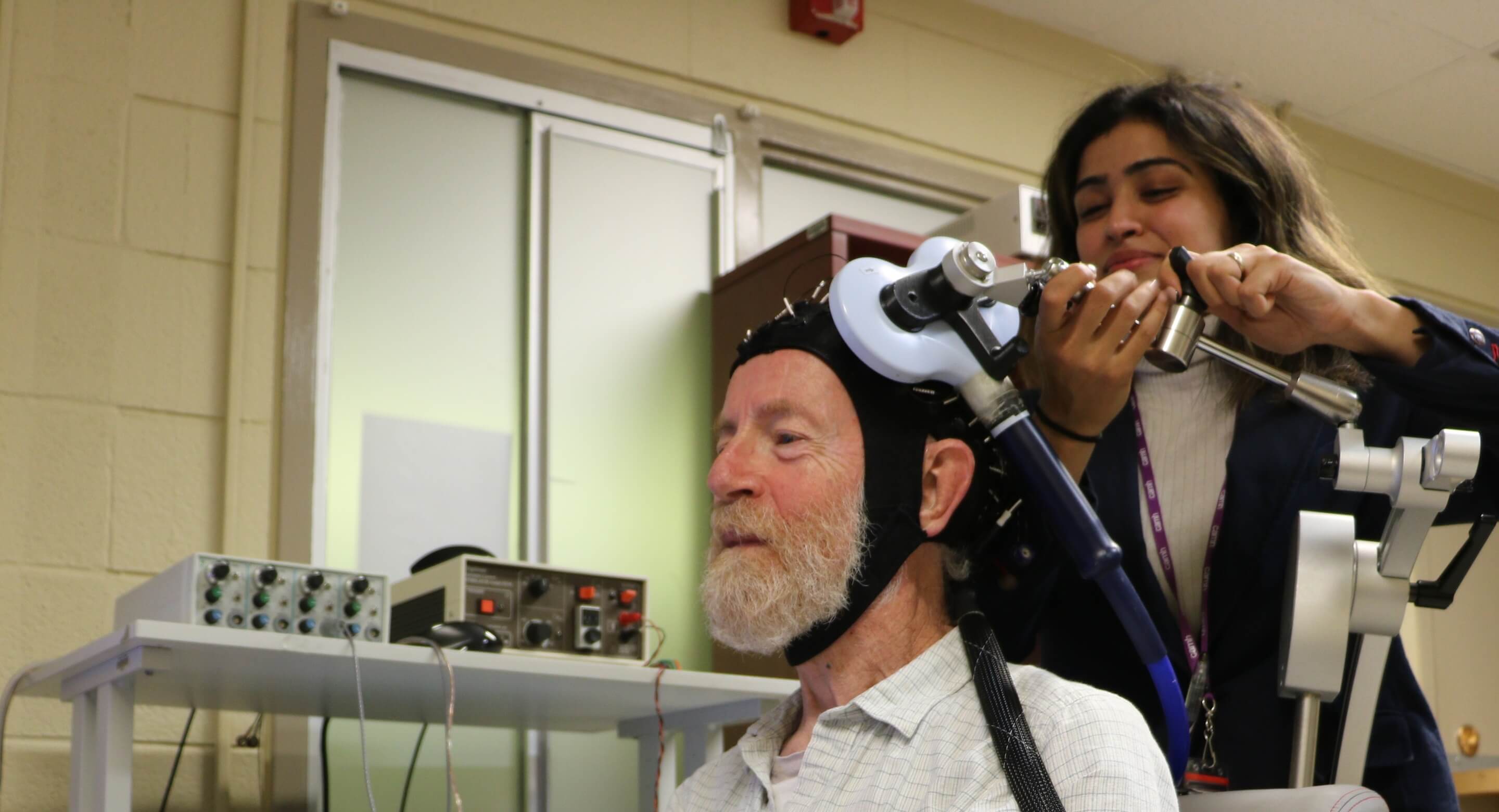 Don Palmer, a research volunteer, and Apoorva Bhandari, Research Analyst in Geriatric Psychiatry at CAMH, demonstrate the innovative, CAMH-developed approach to study brain plasticity in the frontal lobes