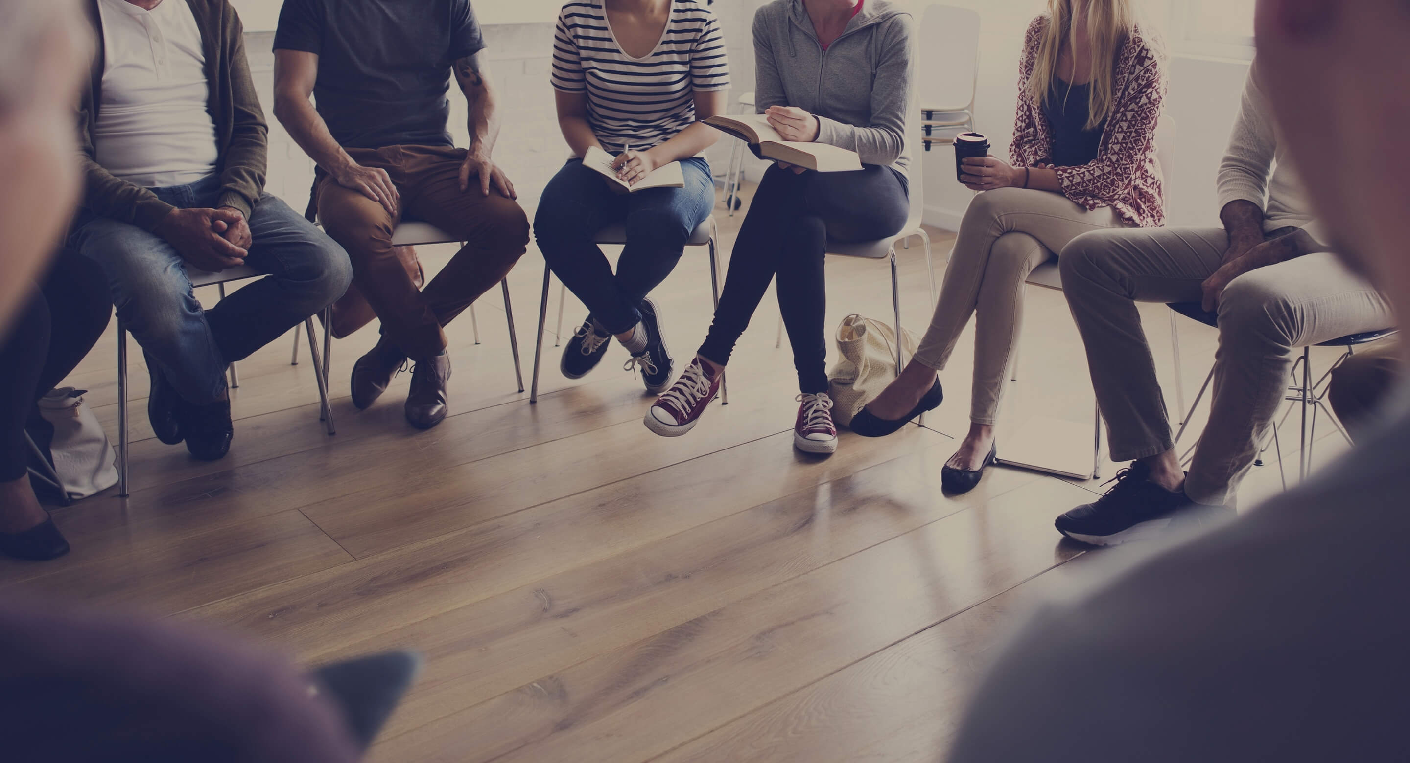 People sitting in a semi-circle with only their legs visible