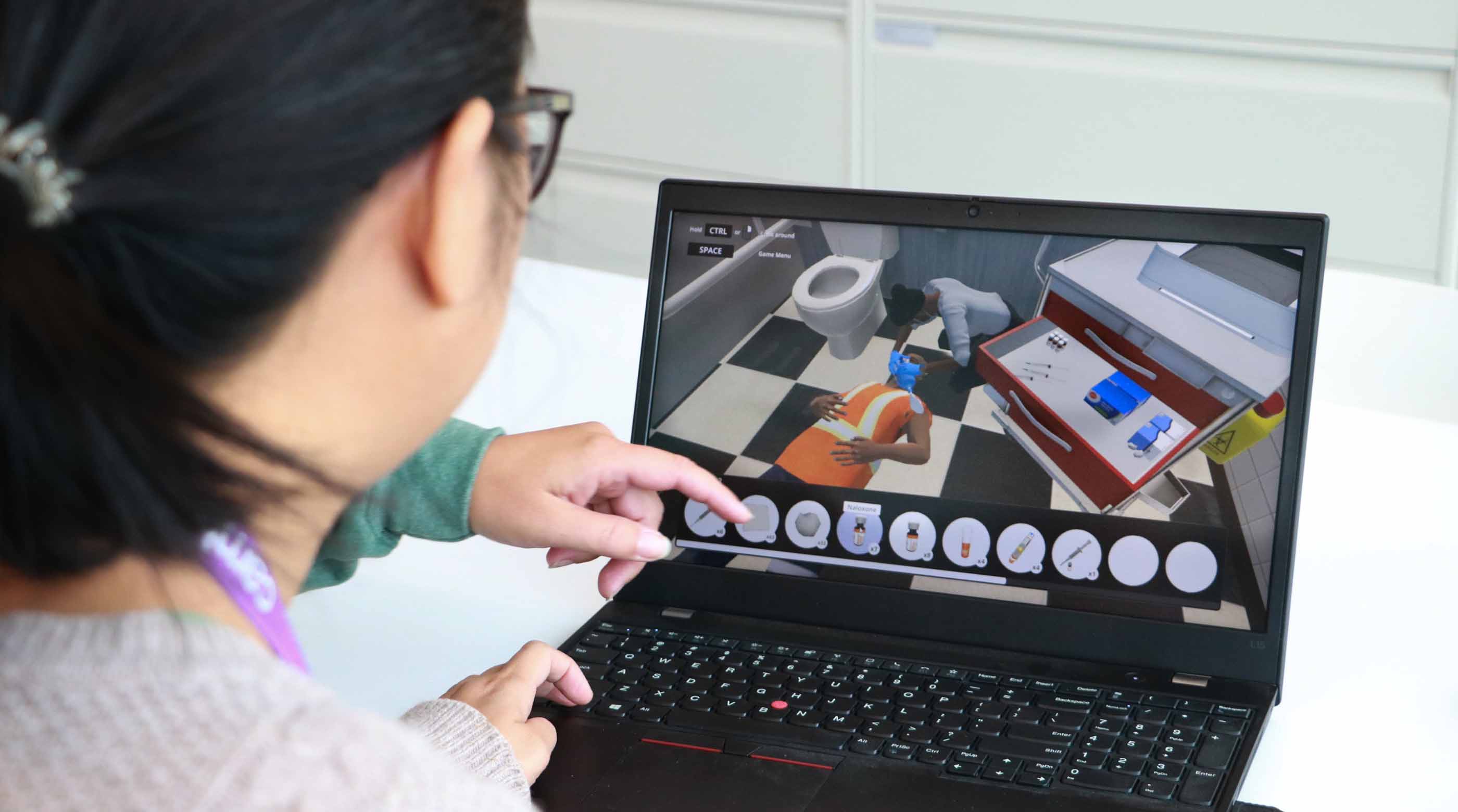 Person on a laptop going through a virtual reality training simulation