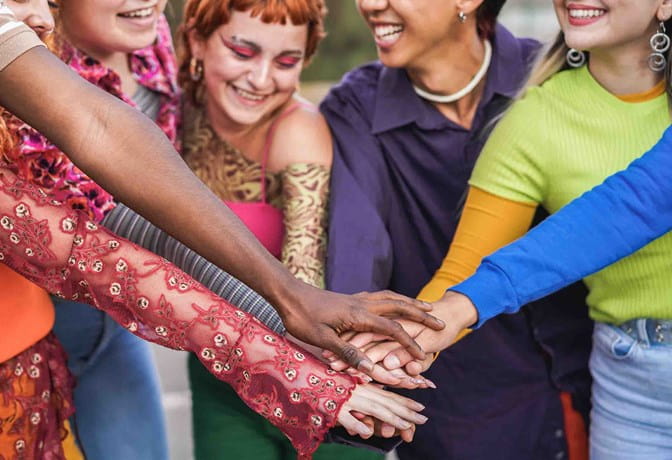 Group of youth putting their hands together