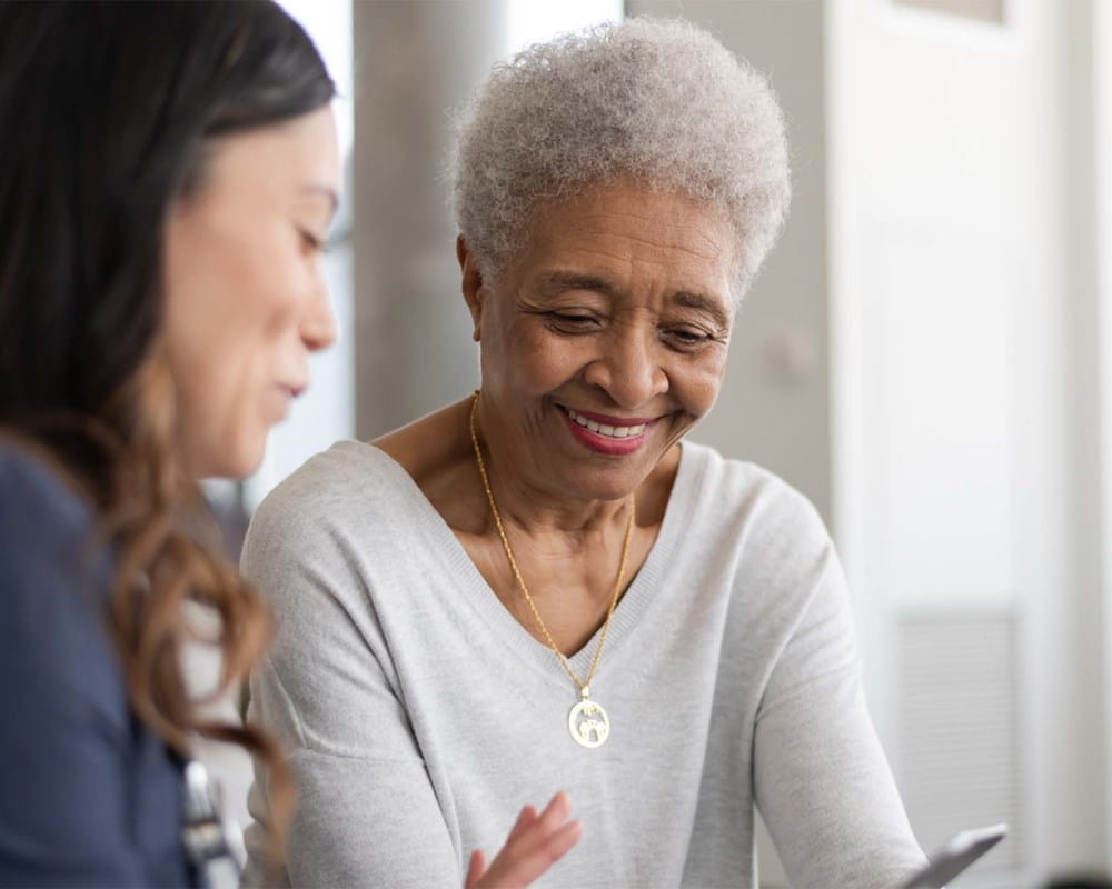two women looking at a phone or tablet