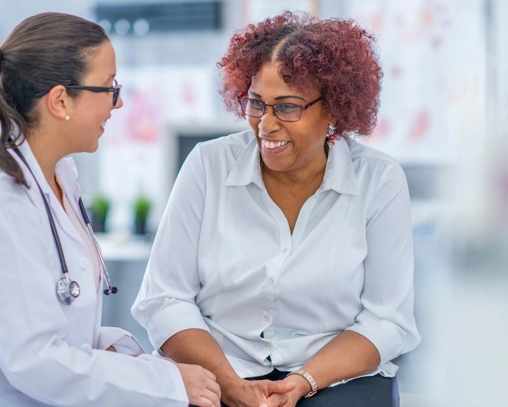 A doctor speaking to her patient