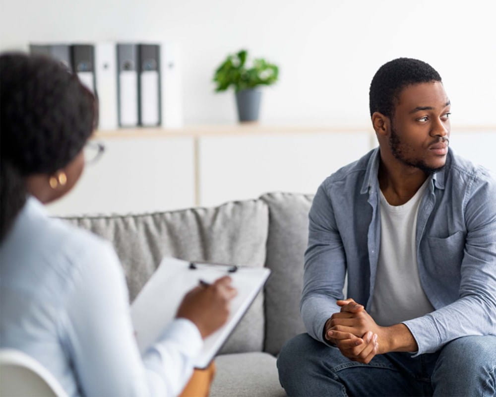 Person on a couch speaking with a therapist