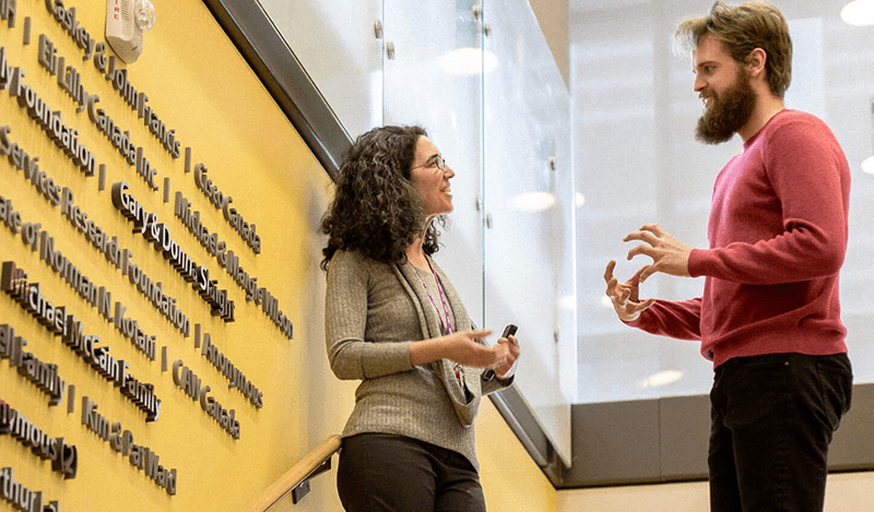 Azrieli Centre - Yona Lunsky talking to a colleague on BGB stairs