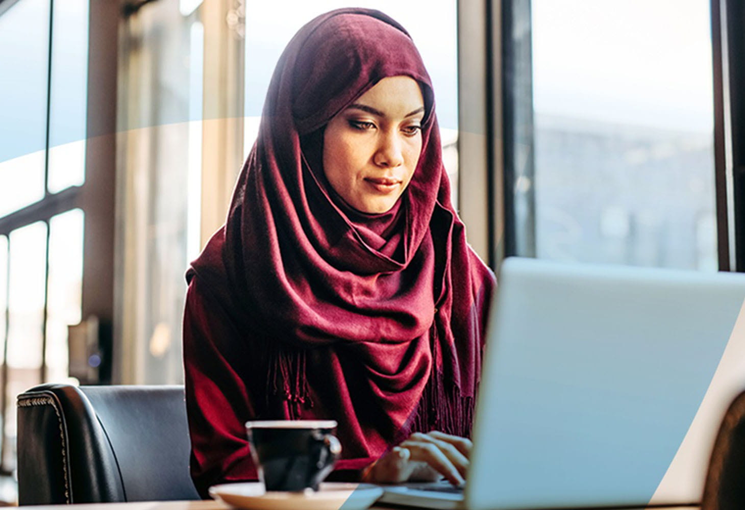 Woman in a hijab on a laptop
